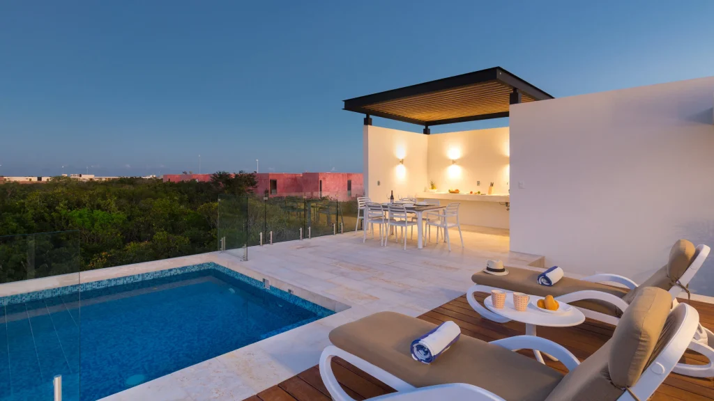 Studio Penthouse — rooftop plunge pool and lounge at dusk