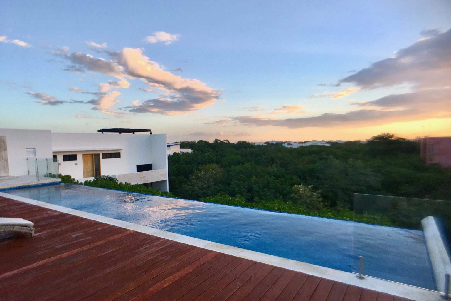 Rooftop infinity pool at golden sunset