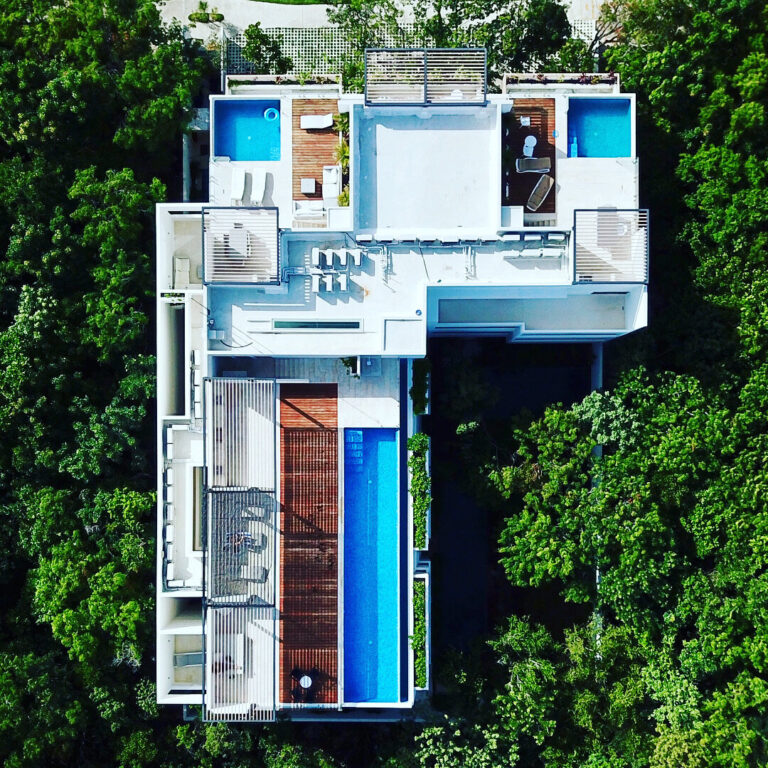Aerial view of The Highline Tulum: the shared rooftop infinity pool at center and the Penthouse Studio private plunge pool at top right, surrounded by Aldea Zama jungle